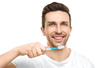 A man brushing his teeth.