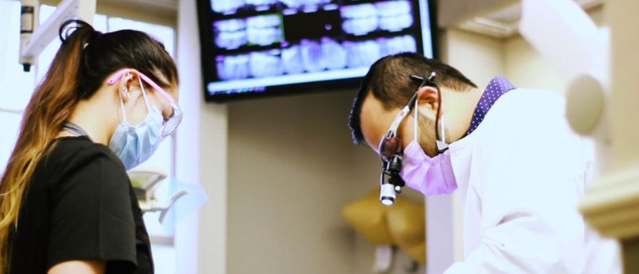 A dentist with an assistant during a procedure.