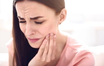 Woman suffering from dental pain.