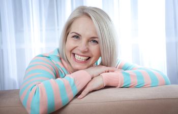 A broadly smiling woman happy with her new dentures Marietta GA