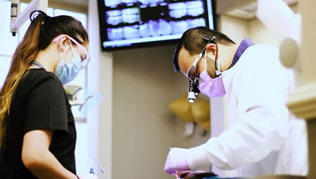 Dentist with an assistant during work