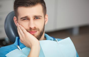 A man with tooth pain in a dentist chair before root canal treatment Marietta GA