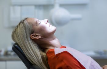 A woman in a dentist chair under dental sedation Marietta GA