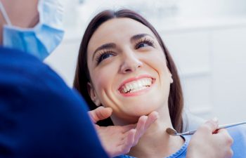 A woman in a dentist chair undergoing gum checkup